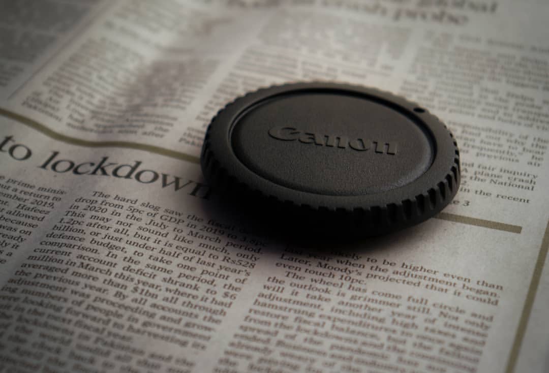image of a camera lens on a newspaper