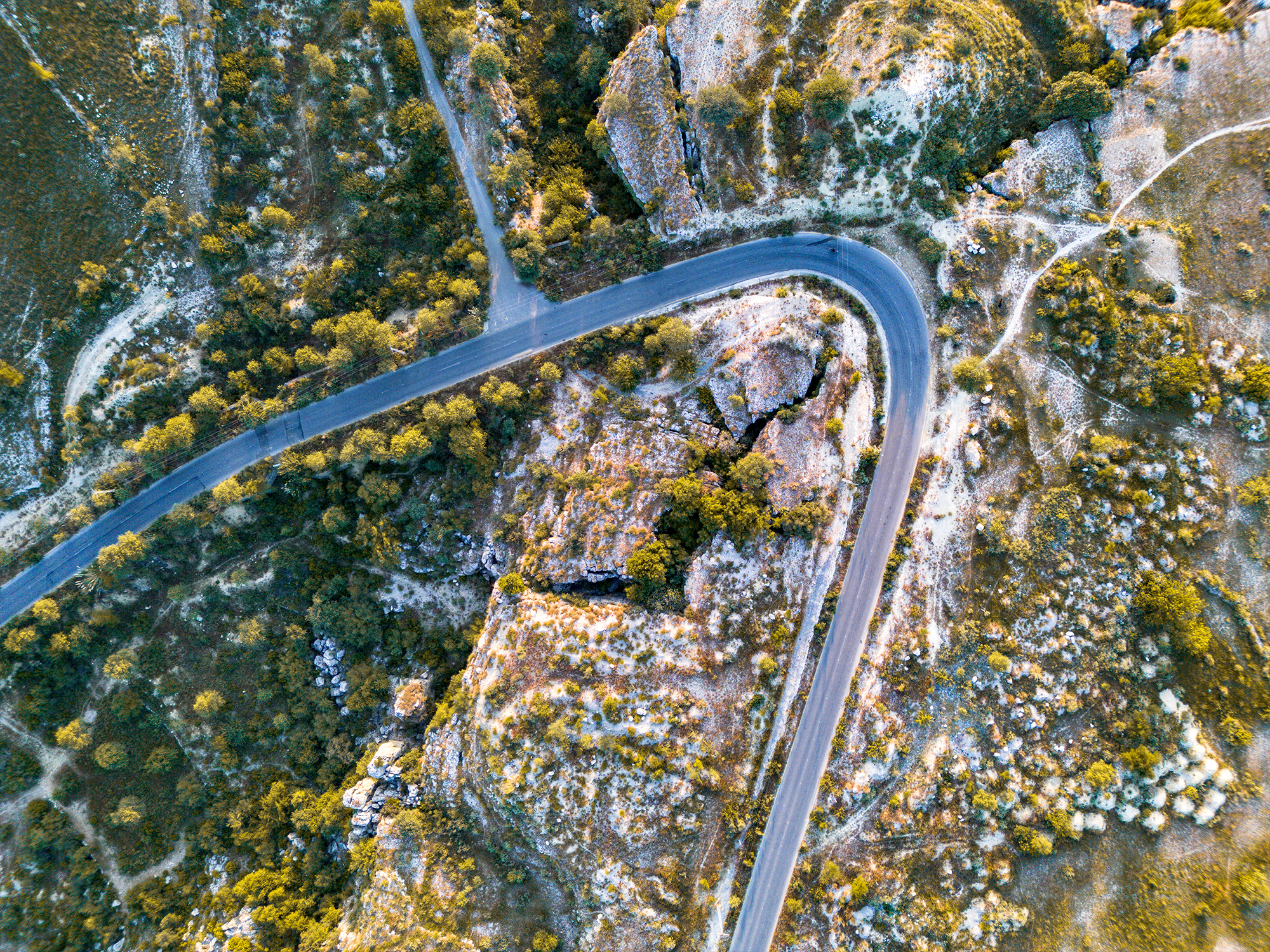 aerial view of a road winding through mountains