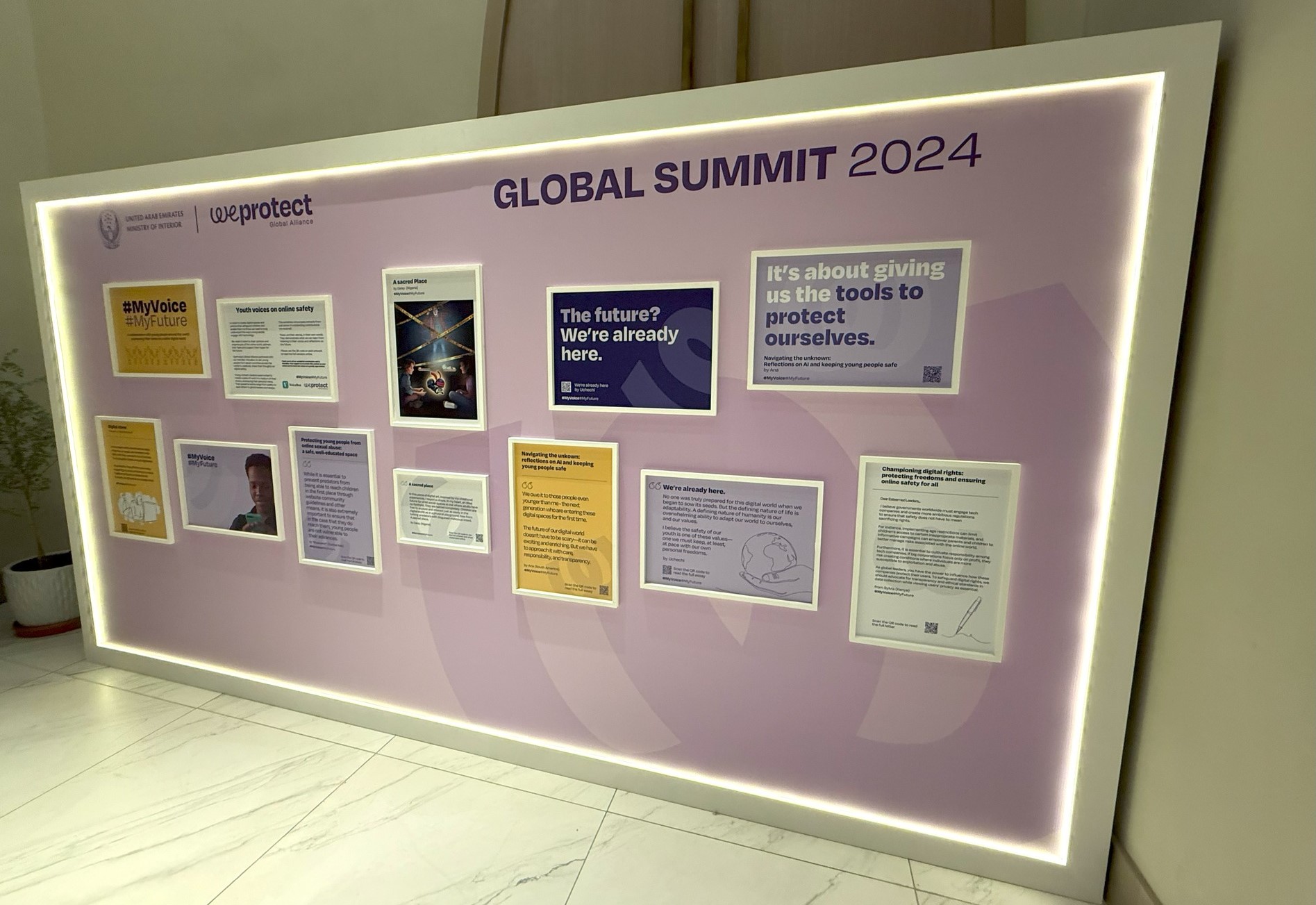 a display board featuring various framed works from the VoiceBox x WeProtect Project