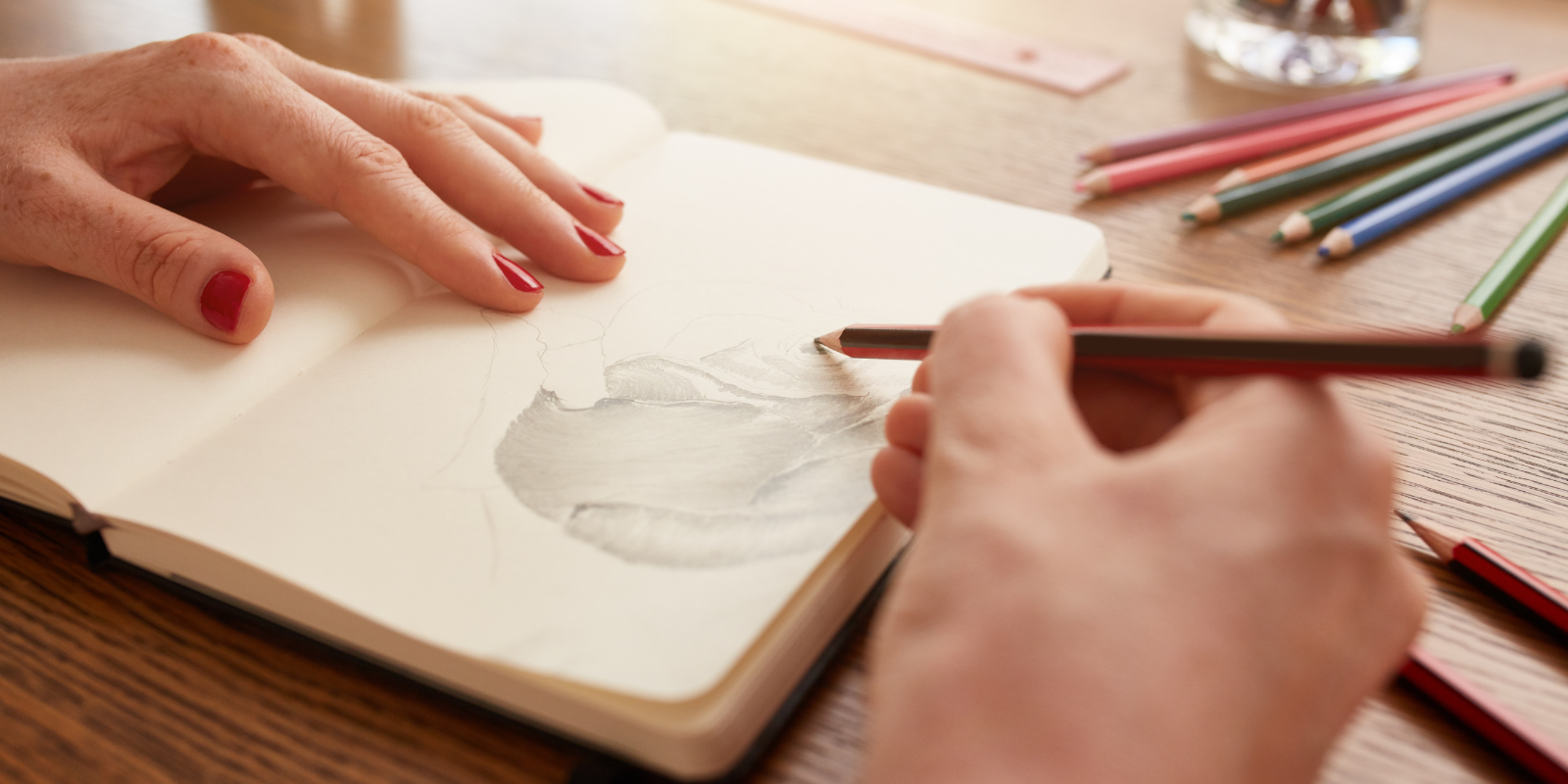 woman sketching in a sketchbook