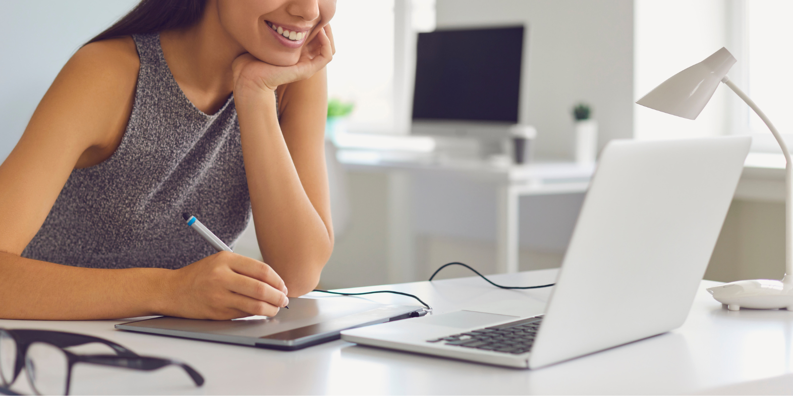 woman sitting at a desk on her laptop