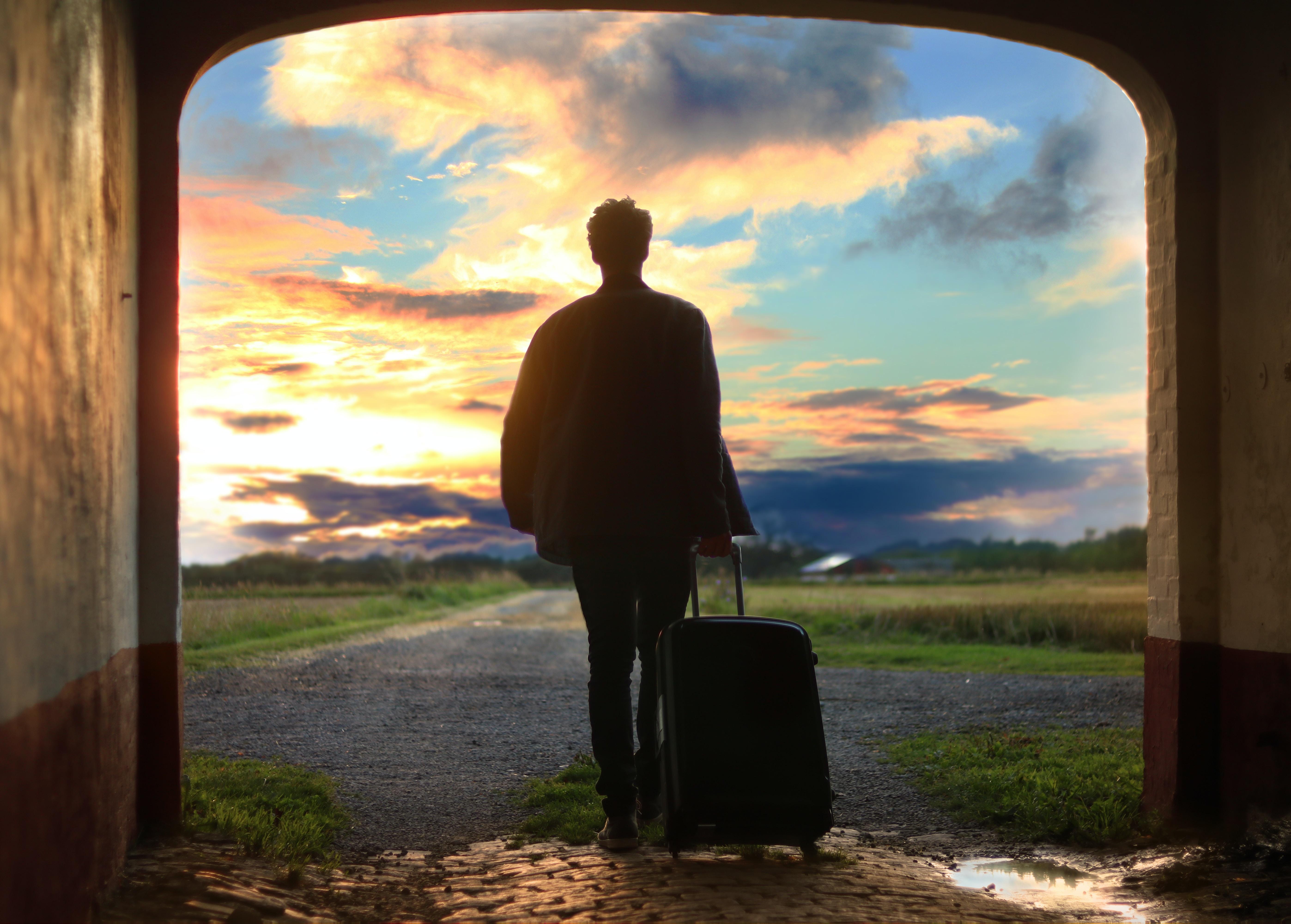 person walking through an archway