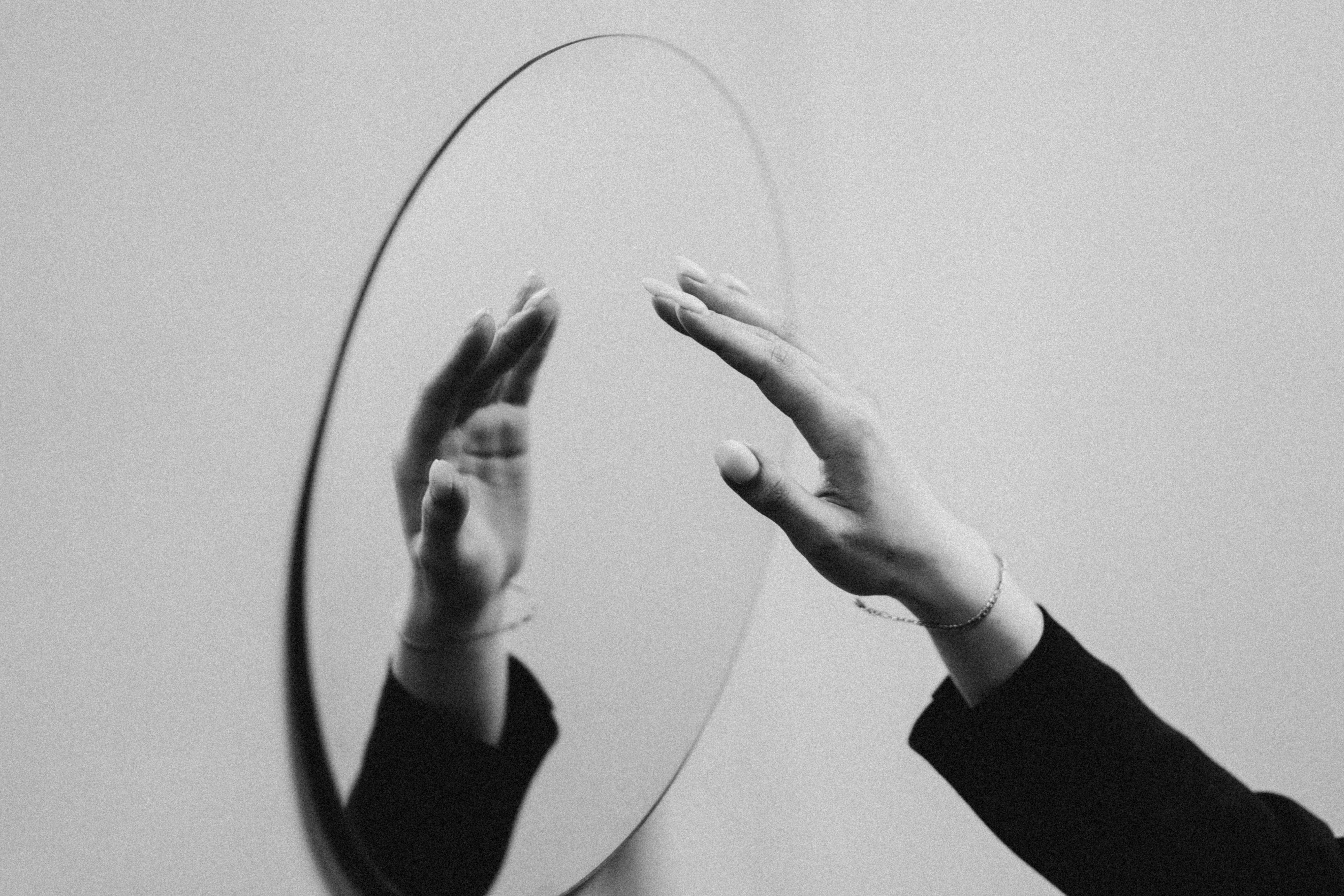 woman reaching for a mirror