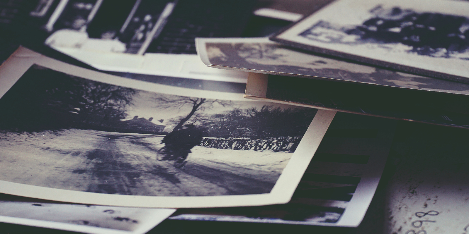 pile of old photographs on a table
