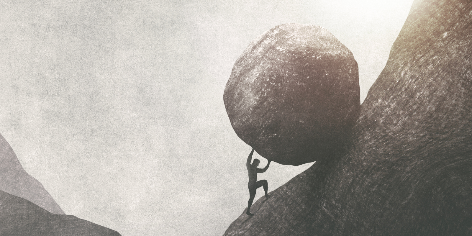 man pushing a bolder up a hill