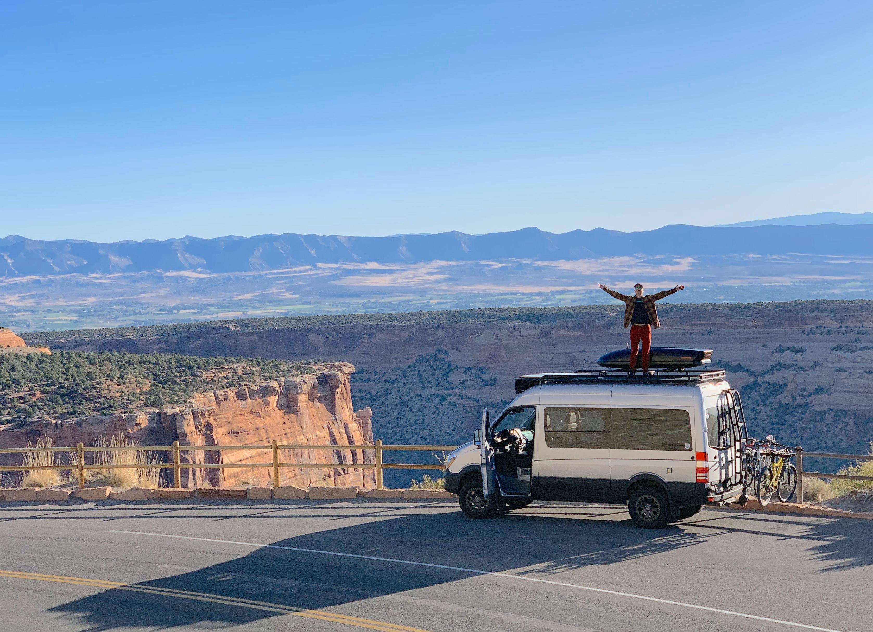 person standing on the roof of a van