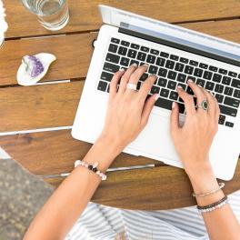 Image of table and someone typing on a keyboard