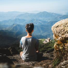 man sitting overlooking the mountains
