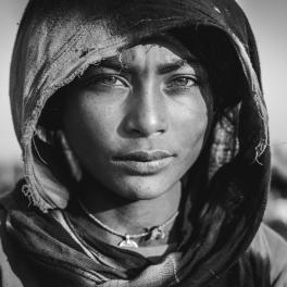 Grayscale photo of a woman looking into a the camera