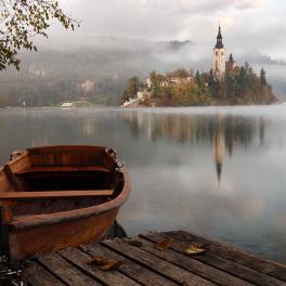 a boat on the water with a castle in the background