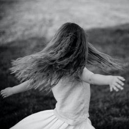 black and white photo of a girl spinning around