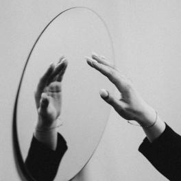 woman reaching for a mirror