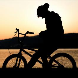 young boy sitting on a bike