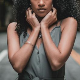 young black woman standing on a street facing the camera