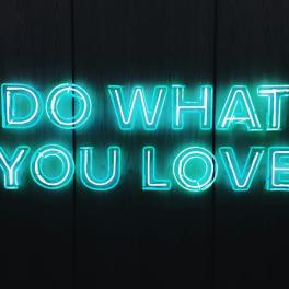 "do what you love" written by a blue neon sign