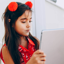 young girl looking at a tablet screen
