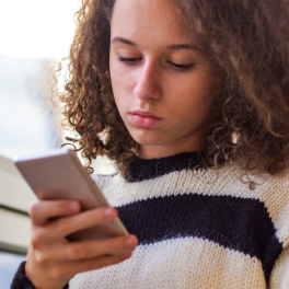 a teen girl looking at her cellphone