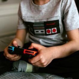 a young boy holding a video game controller
