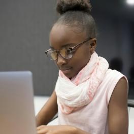 a young girl using a laptop