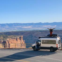 person standing on the roof of a van