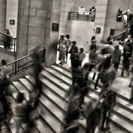black and white staircase full of people
