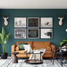 a living room with a blue wall, a couch, wall art and plants