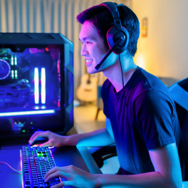 A young man playing a game on his pc