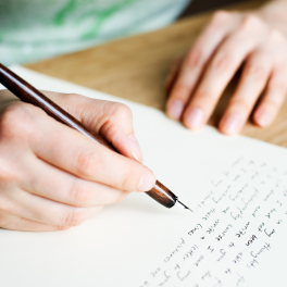 person writing a letter