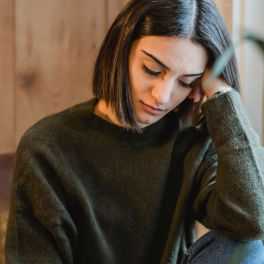 Sleepy woman resting her head on her hand with her eyes closed