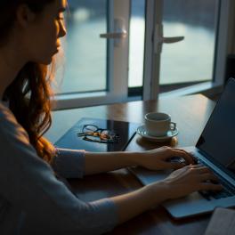 woman typing on her laptop at a desk