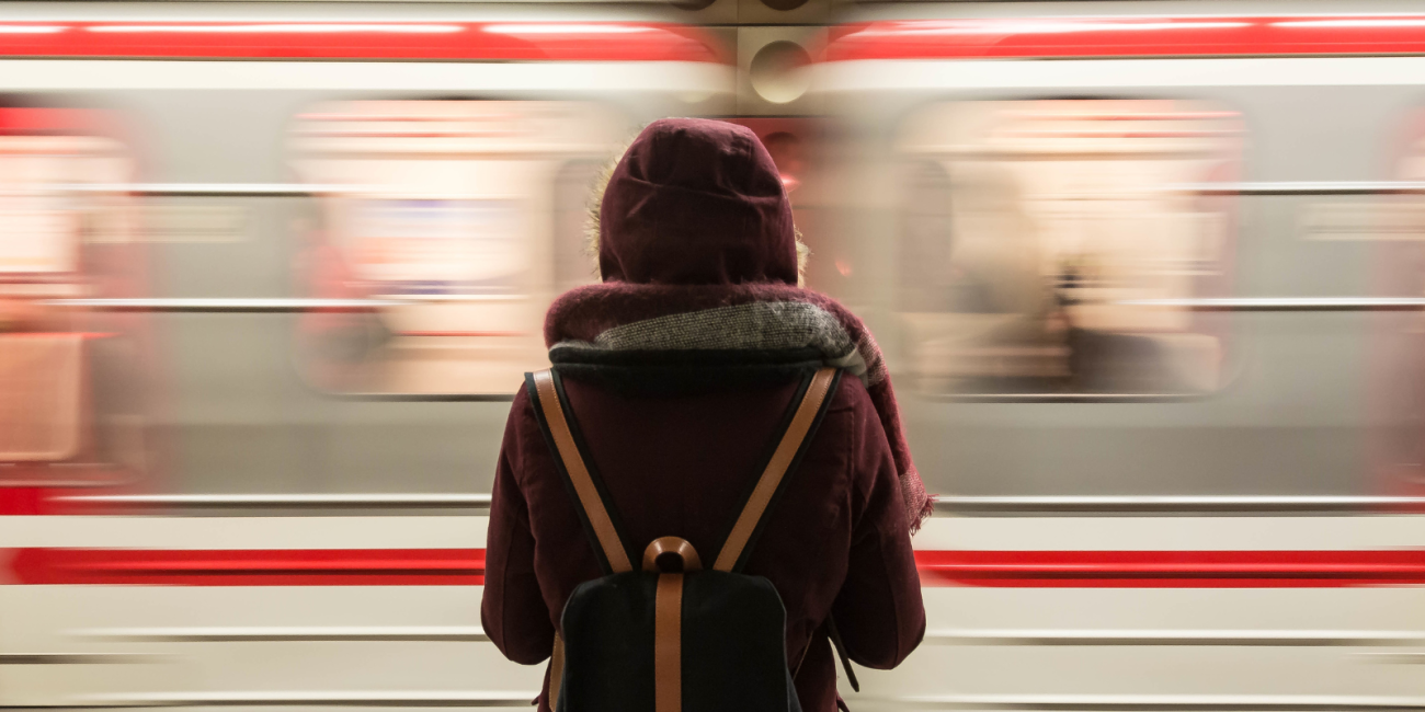 woman standing in front of a train