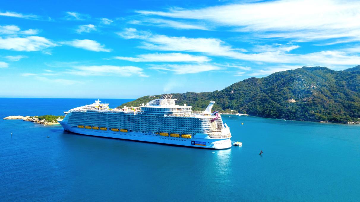 cruise ship docked at an island