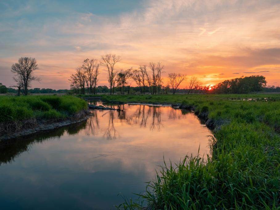 photo of a river at sunset 