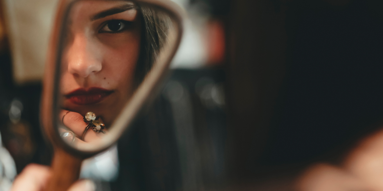 woman looking in the mirror