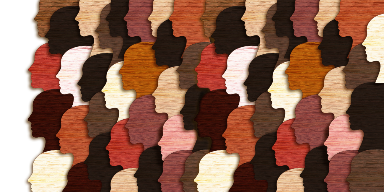 Paper cutouts of human head silhouettes of different shades