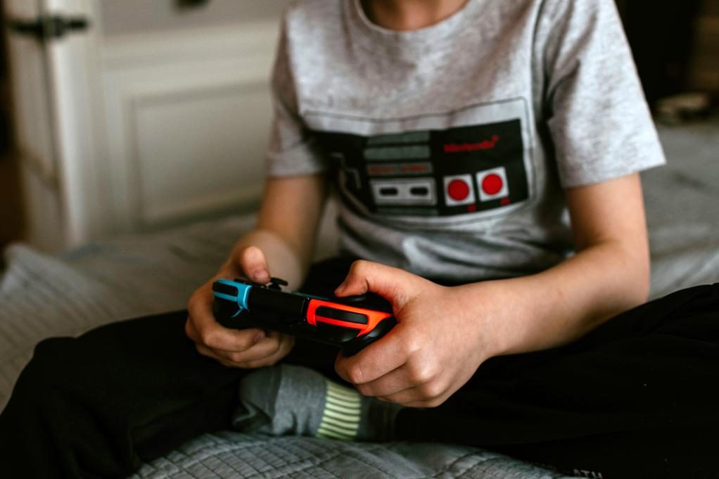 a young boy holding a video game controller