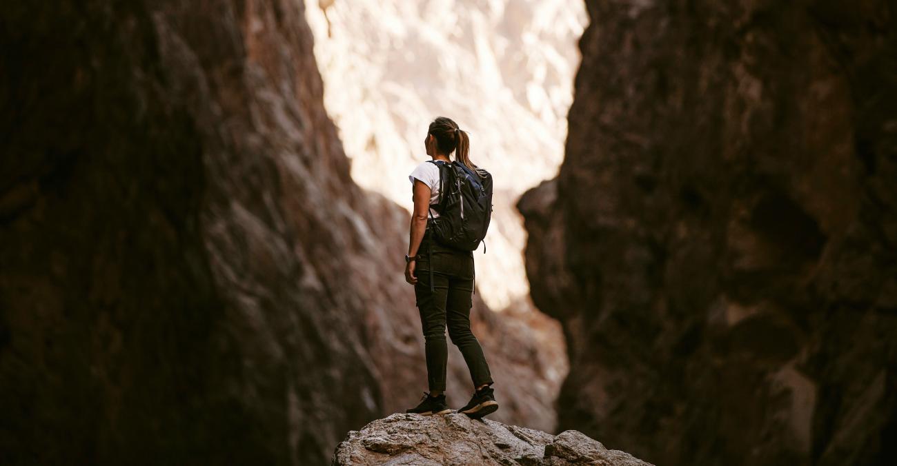 woman standing in a canyon in hiking attire