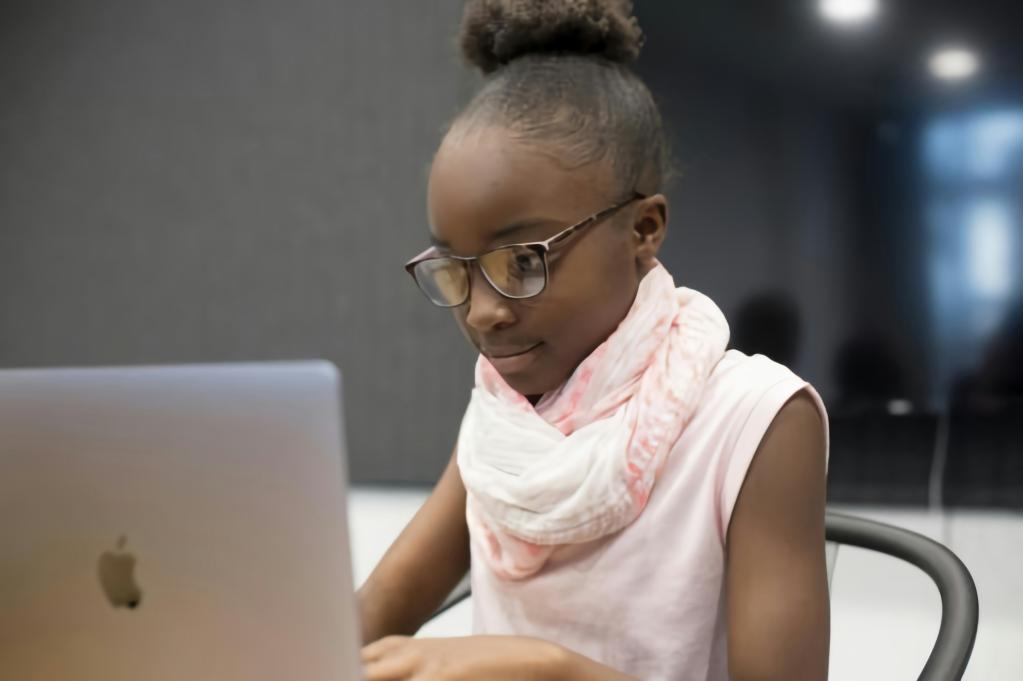 a young girl using a laptop