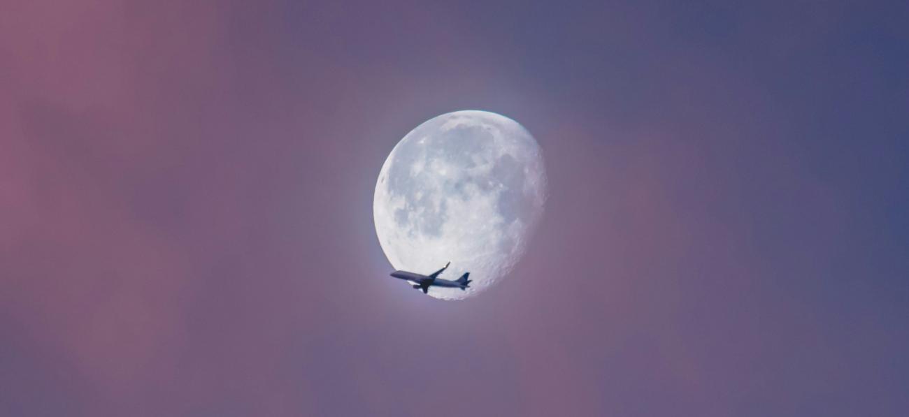 plane passing in front of moon