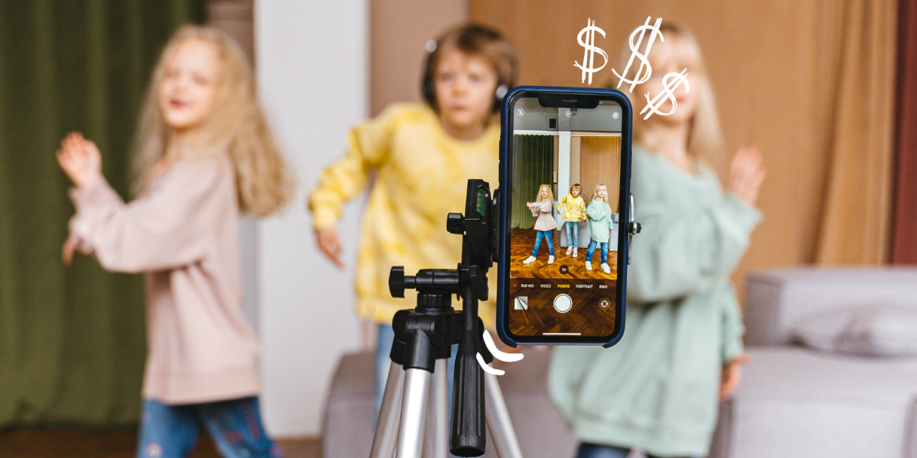 Children filming a video in front of a smart phone on a tripod
