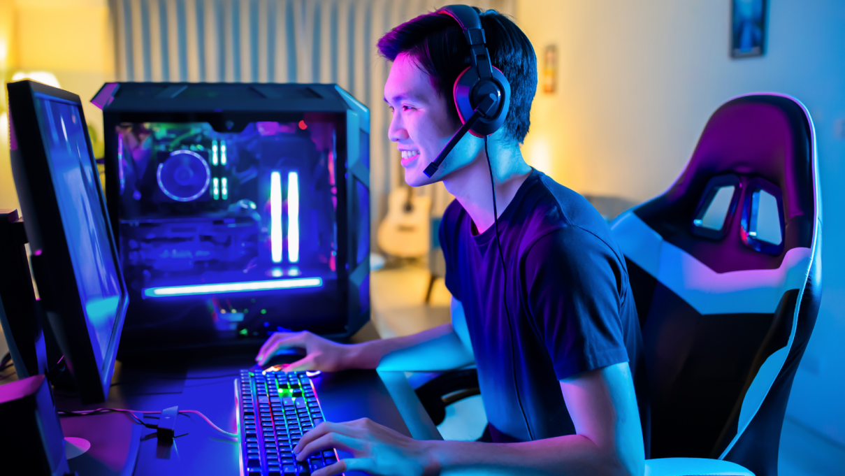 A young man playing a game on his pc