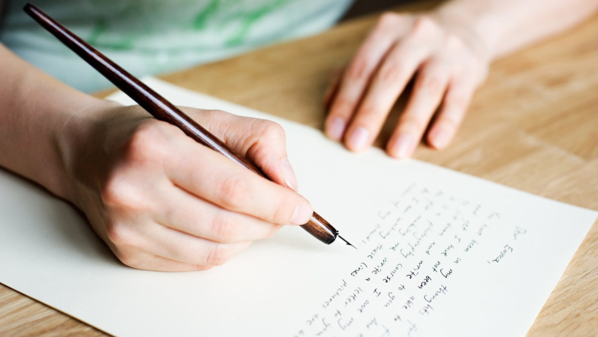 person writing a letter