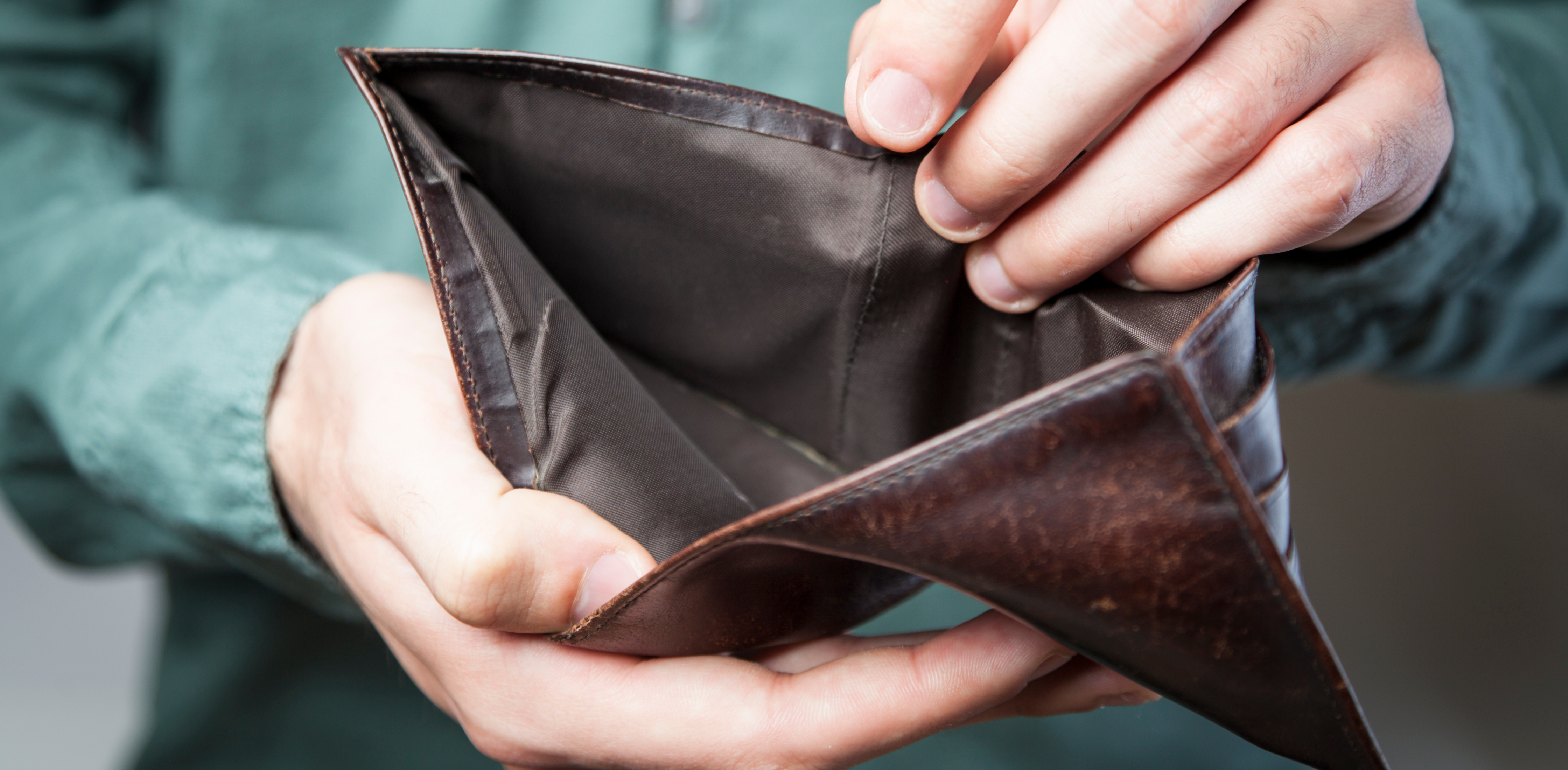 man holding an empty wallet open